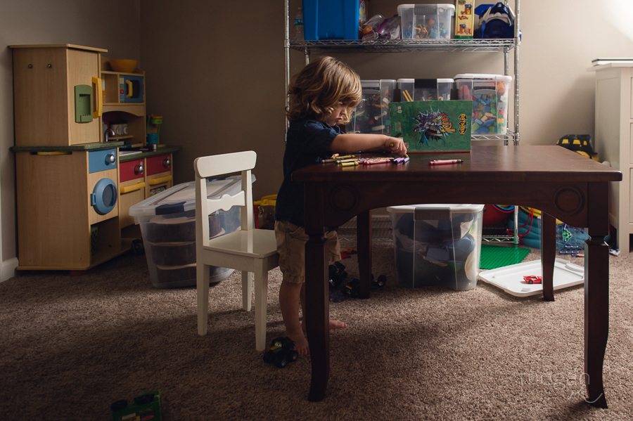 Child colors at a small table