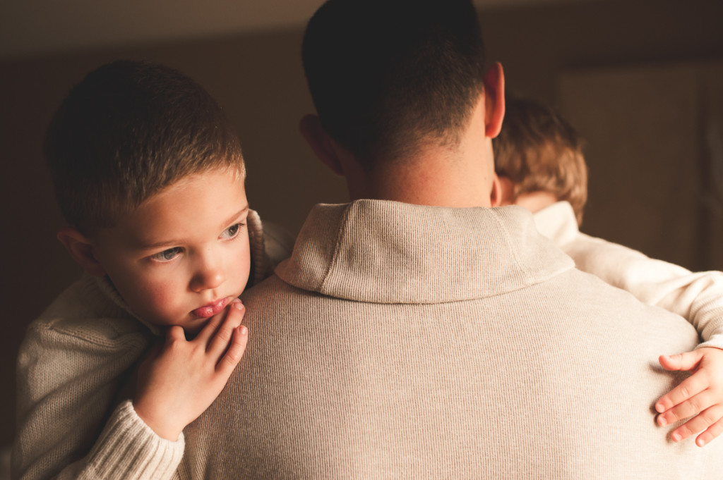 photo of 2 young boys held in their dad's arms by megan cieloha