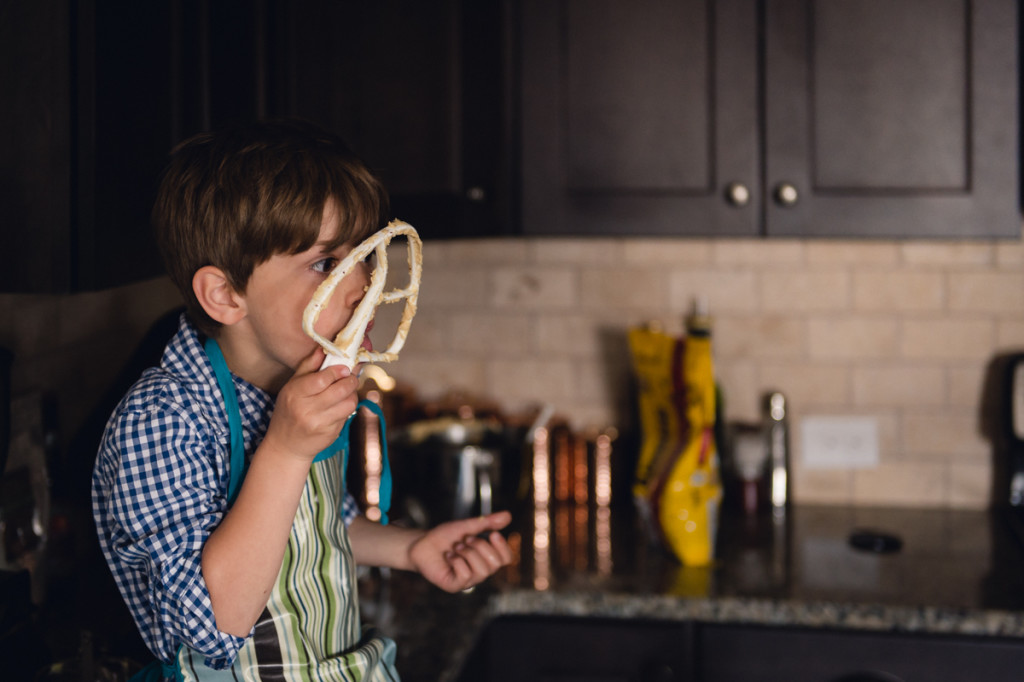 child with mixing beater in natural light by megan cieloha