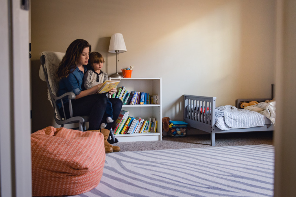 self portrait with toddler while reading a book by megan cieloha