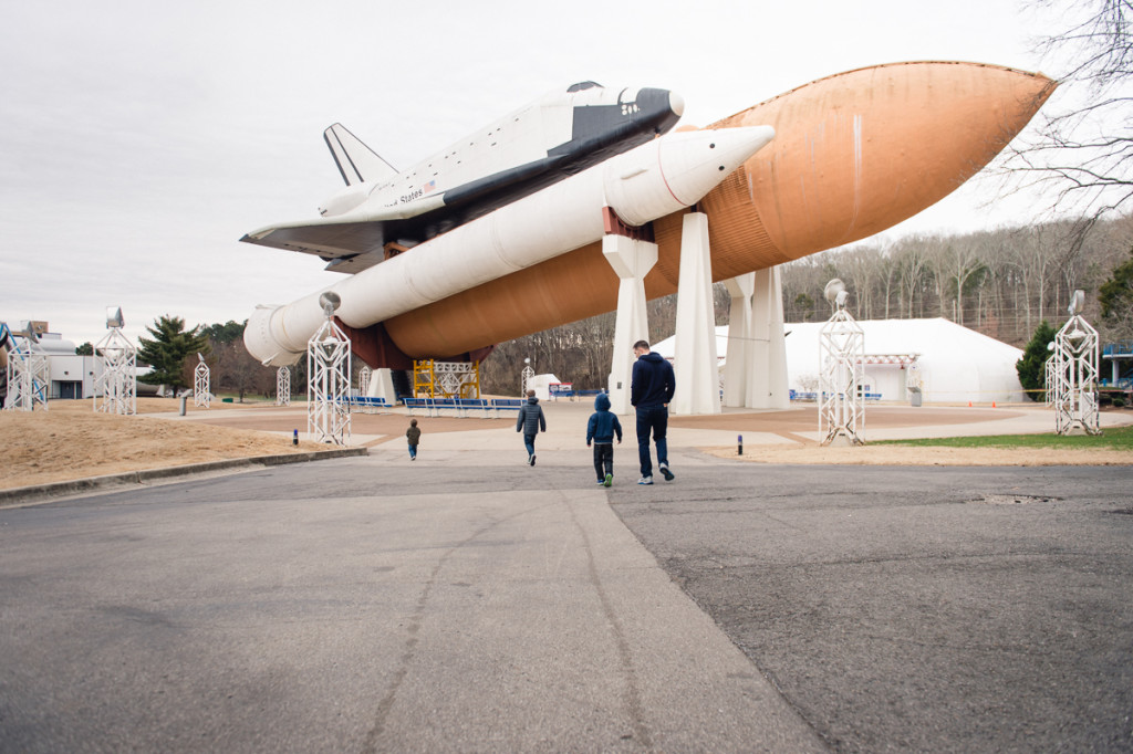 family walks underneath space shuttle by megan cieloha
