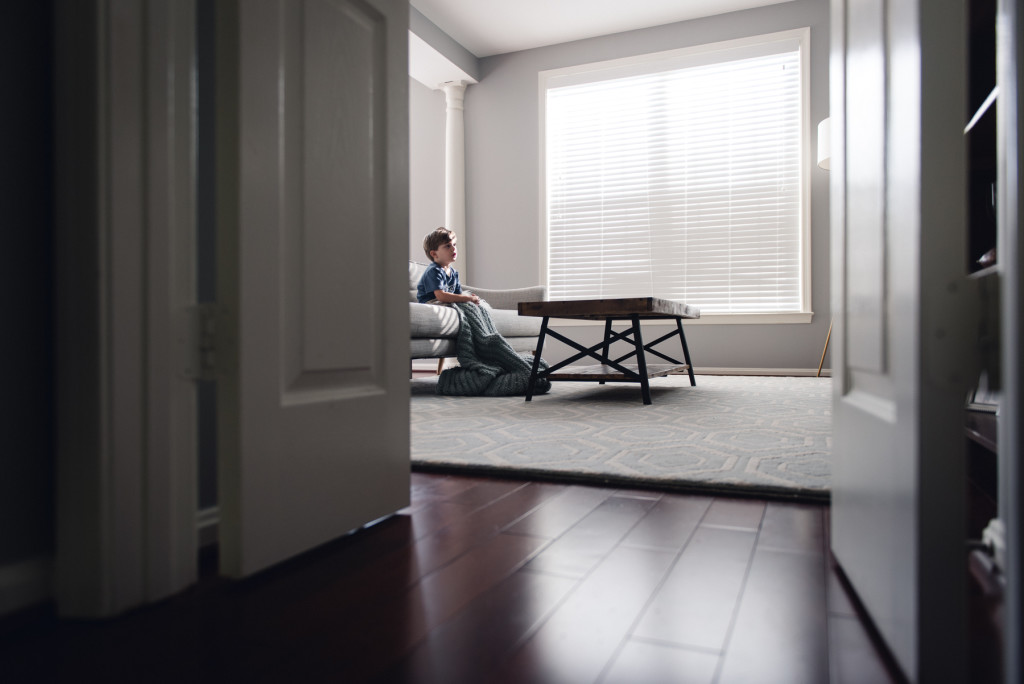 environmental portrait of child on a couch in natural light photo by megan cieloha