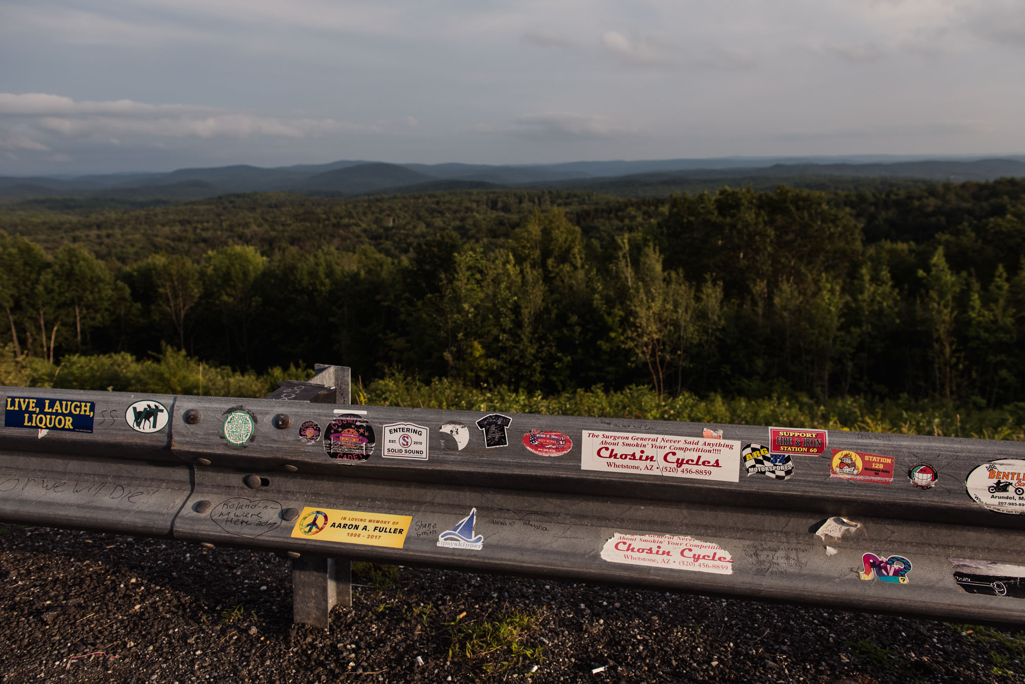 bumper stickers on guard rail in vermont picture by megan cieloha